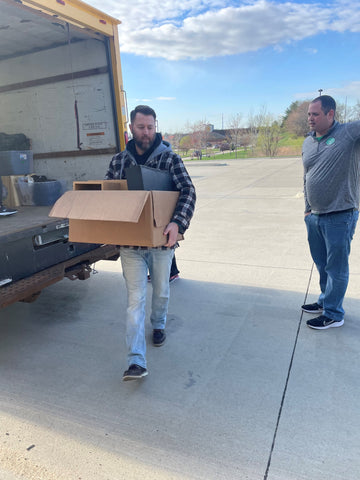 TTMT employee unloading a box from a truck